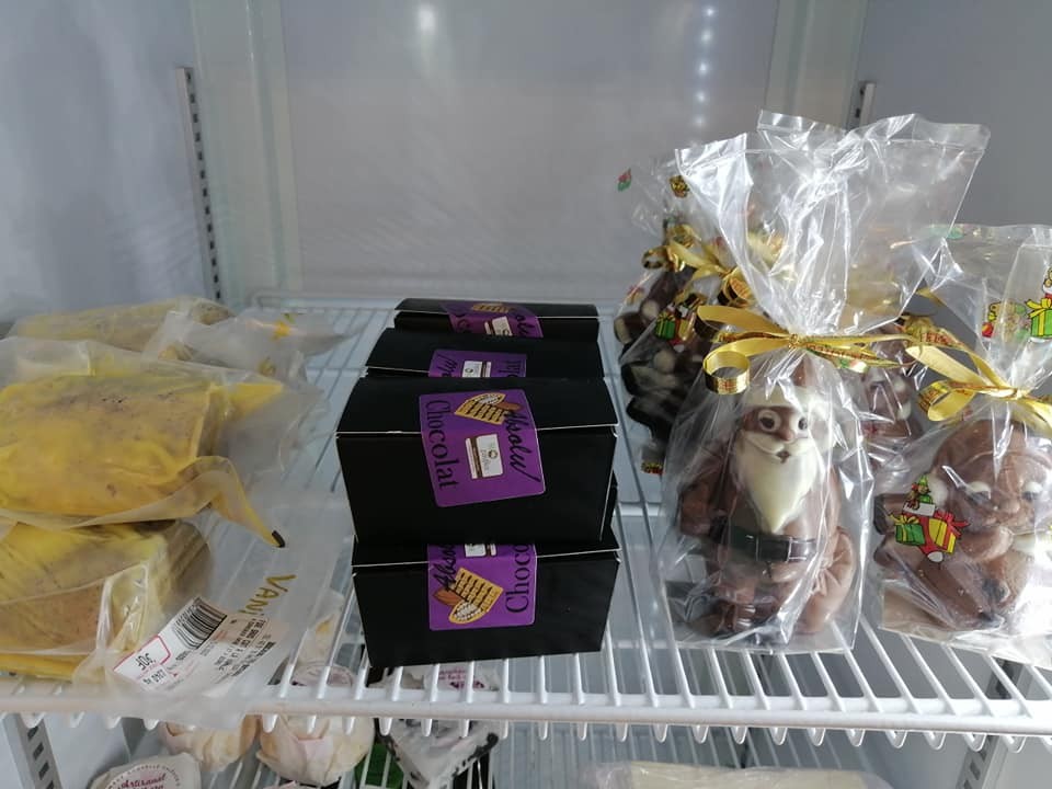 Chocolats de Noël emballés et coffrets de chocolats, dans un présentoir réfrigéré.